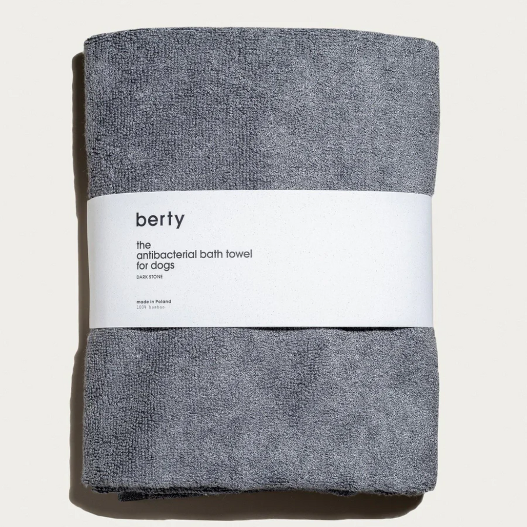 A neatly folded antibacterial bath towel for dogs, labeled 'berty,' in a dark stone color. Made from 100% bamboo, this eco-friendly, high-quality towel is designed for conscious dog parents who prioritize sustainable, natural dog grooming products. Perfect for maintaining hygiene while being gentle on the environment.