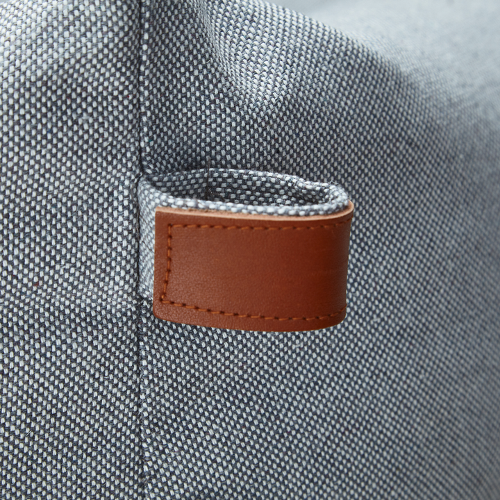 Close-up of durable fabric and leather tag on the Cloud7 SLEEPY DELUXE TWEED Dog Bed in light grey tweed.