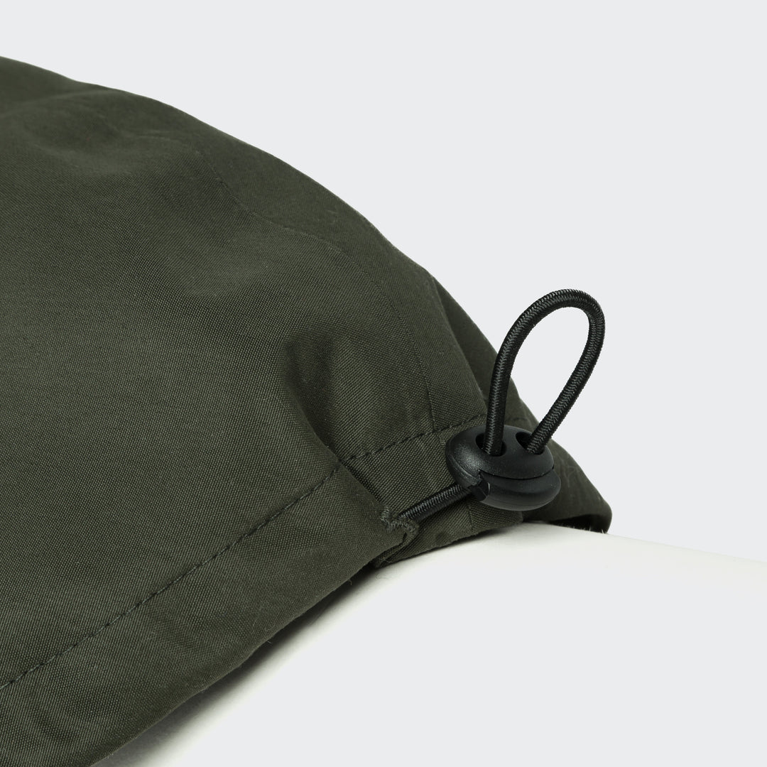 Close-up of adjustable cord stopper on Cloud7 - Dachshund Raincoat Dublin in olive green fabric.