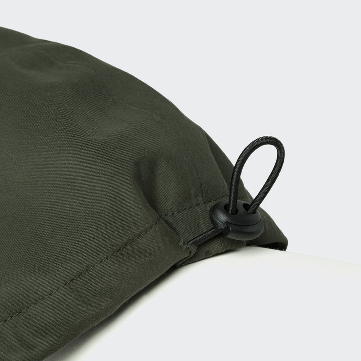 Close-up of adjustable cord stopper on Cloud7 - Dachshund Raincoat Dublin in olive green fabric.