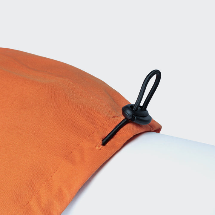 Cloud7 - Dachshund Raincoat Dublin close-up of adjustable back length cord stopper on orange fabric.