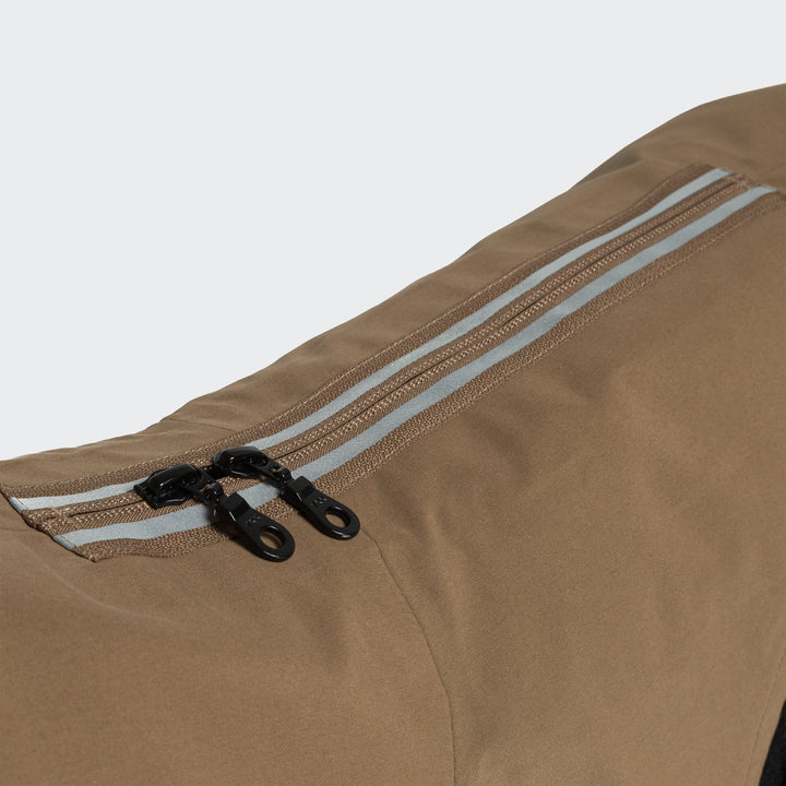 Close-up of reflective dual zipper on brown Cloud7 Dog Raincoat Dublin made with recycled water-repellent fabric.